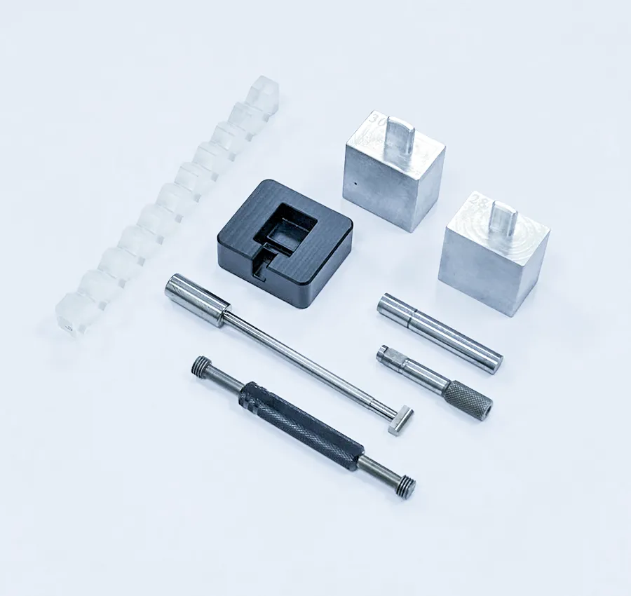 Assorted molds, jigs, and inspection tools including plastic injection mold components and precision metal fixtures